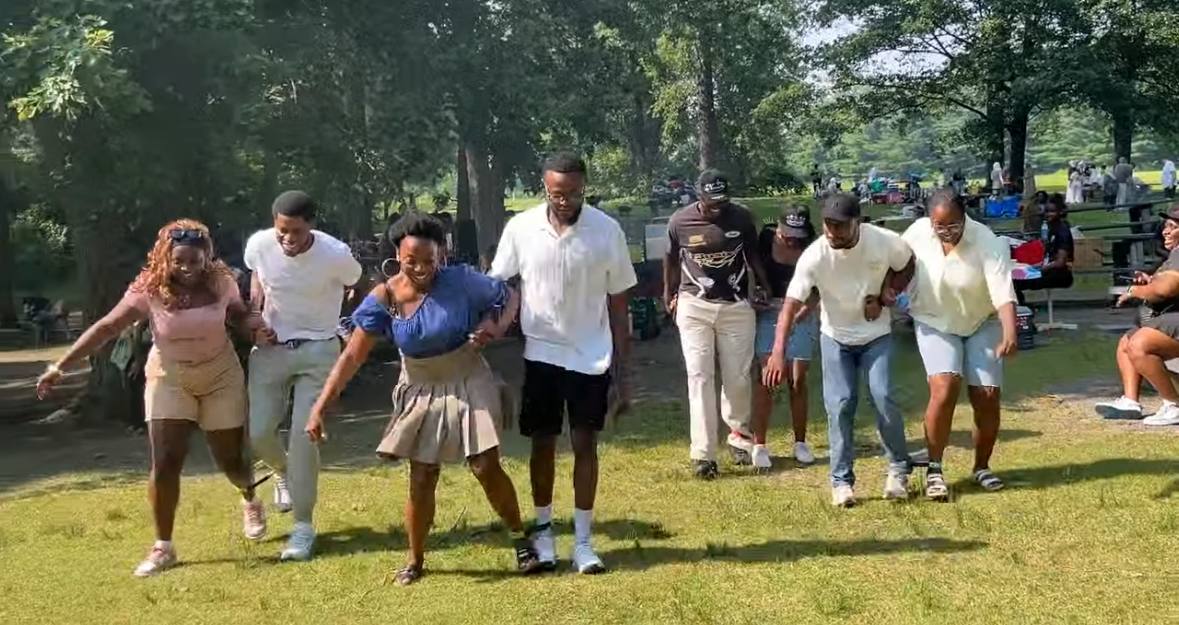Members dancing together outdoors